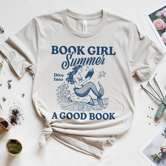 Flat lay of Book Girl Summer tee — heather dust reading graphic shirt with literary theme